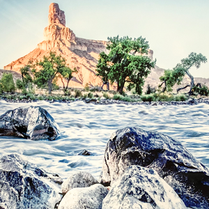 Photo print on metal of the perspective at a rocky shore line looking at the Green River in Utah
